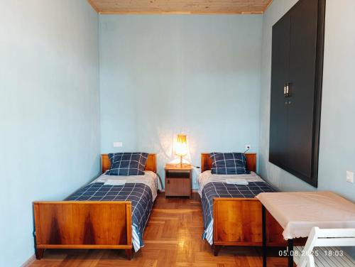 una camera con due letti e una lampada su un tavolo di Cabernet Tali a Telavi