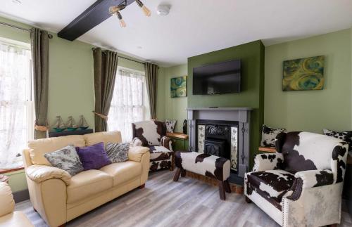 a living room with a couch and a fireplace at Jersey Cottage in Cowes
