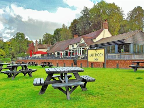 a group of picnic tables in front of a building at Half Moon Jackfield in Bridgnorth