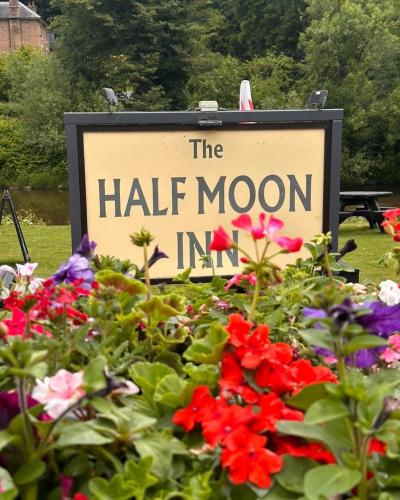 a sign for the half moon inn with flowers at Half Moon Jackfield in Bridgnorth