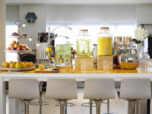 a kitchen with a counter with some fruit and juice at Novotel York Centre in York