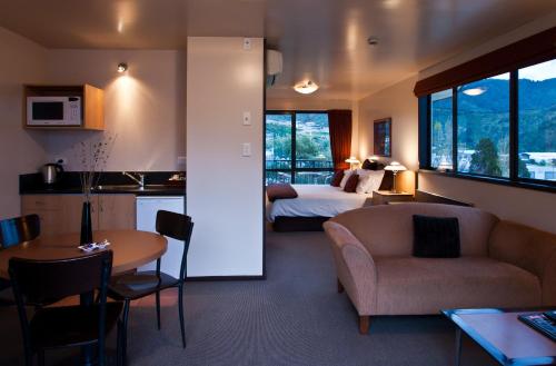 a hotel room with a bed and a living room at Broadway Motel in Picton