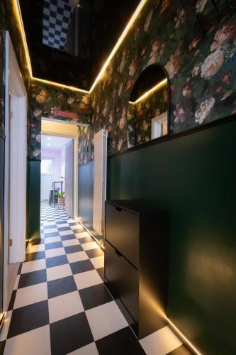 a kitchen with a black and white checkered floor at Checkered Wonderland at 19 Milbanke in Doncaster