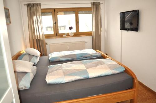 En eller flere senge i et værelse på Mayers Urlaubsnest