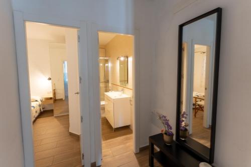 a bathroom with a mirror and a sink at Casa Abril by Escape Home in S'Algar