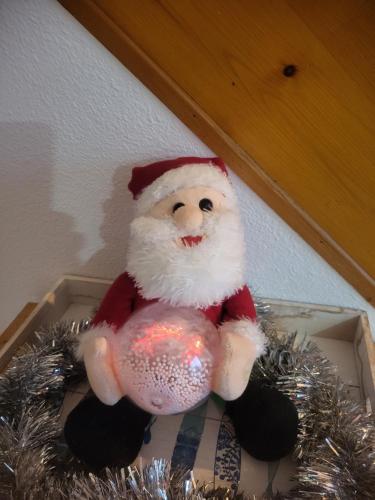 a santa claus toy sitting in a box at Appartement cosy vue port in Dives-sur-Mer