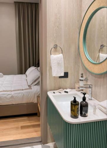 a bathroom with a sink and a bed at Amine Apart-Hotel by Stayinn in Beirut