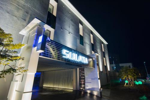 a building with a sign on the side of it at HOTEL SULATA Sapporo (Adult Only) in Sapporo