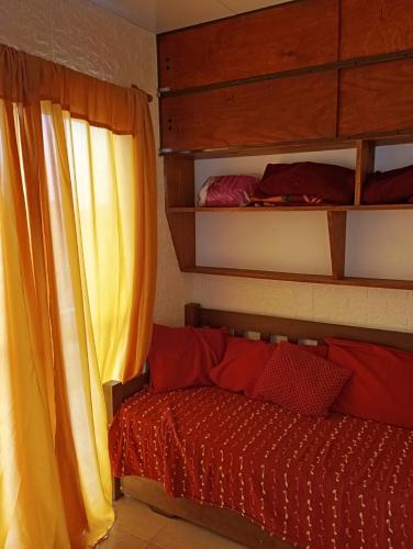 a bedroom with a bunk bed and a window at Brisa de Mar. in La Pedrera