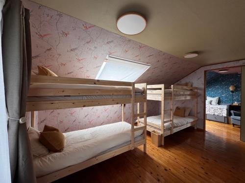 a room with two bunk beds and a mirror at カタツムリ in Shiogama