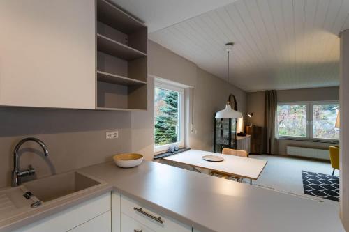 a kitchen with a counter top and a table at Haus am Sagenweg in Nothweiler
