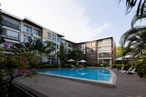 a swimming pool in front of a building at The Pearl In City by WOW Property - Direct from developer in Accra