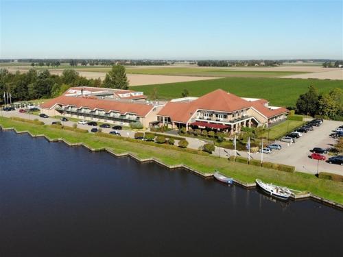 an aerial view of a resort next to a river at Van der Valk Hotel Emmeloord in Emmeloord