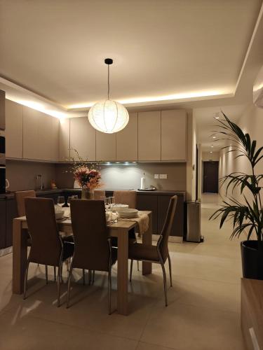 a kitchen and dining room with a table and chairs at Veduta Ta Pinu Apartments with Stunning Views Garden Sauna Pool and Gym in Għarb