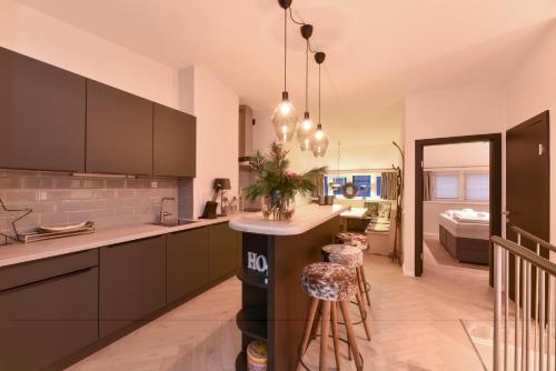 a kitchen with a island in the middle of a room at Penthouse Mountain and Lake View, terrace, AirCondition, incl Summer Card in Zell am See