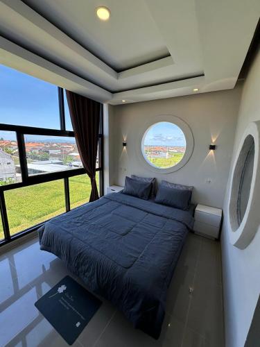 a bedroom with a large bed and a window at On The Moon in Ketewel