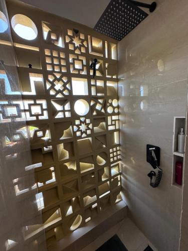 a wall with shelves and lights in a room at On The Moon in Ketewel