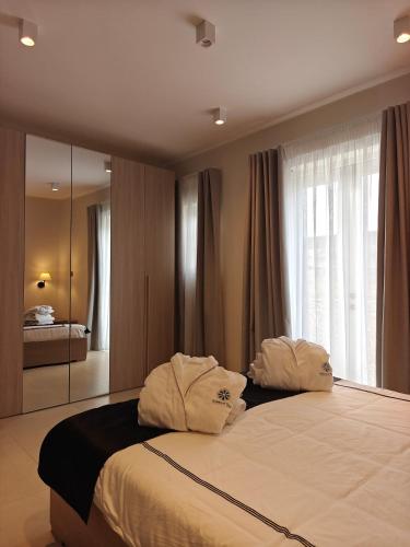 a bedroom with a large bed with a large window at Veduta Ta Pinu Apartments with Stunning Views Garden Sauna Pool and Gym in Għarb