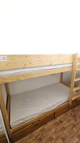a wooden bunk bed with the bottom shelf at Val Thorens - Ski InOut - 4 Beds Flat C-E19 in Béranger