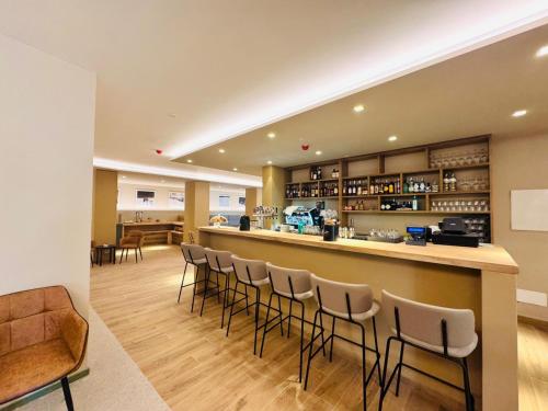 a bar in a restaurant with stools at Lift Hotel in Sauze d'Oulx
