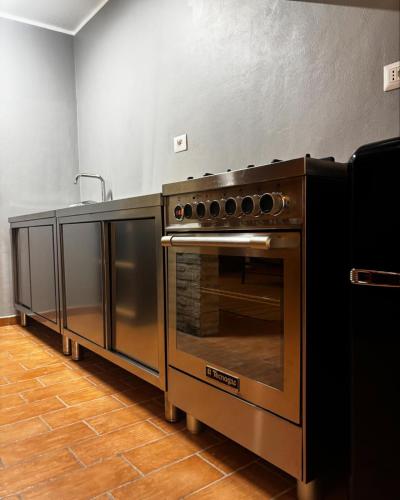 a kitchen with a stainless steel oven and a counter at Casavacanzebrunella in Sassoferrato