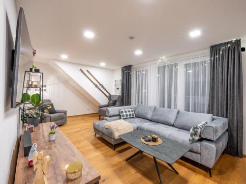 a living room with a couch and a table at Ubytování za Řekou in Hořejší Vrchlabí