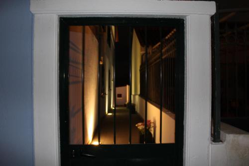 a reflection of a hallway in a door with a window at Hello Terceira in Angra do Heroísmo