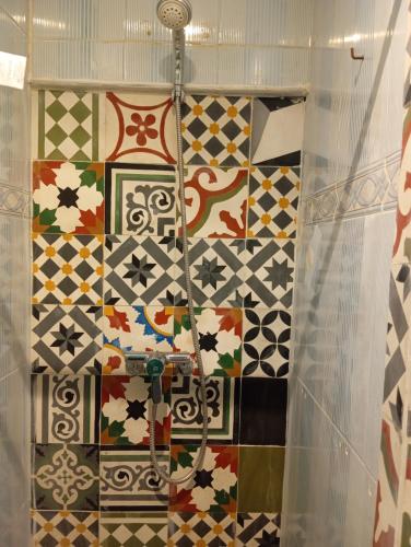 a bathroom with many different types of tiles on the wall at Studio Dar ziane in El Jadida