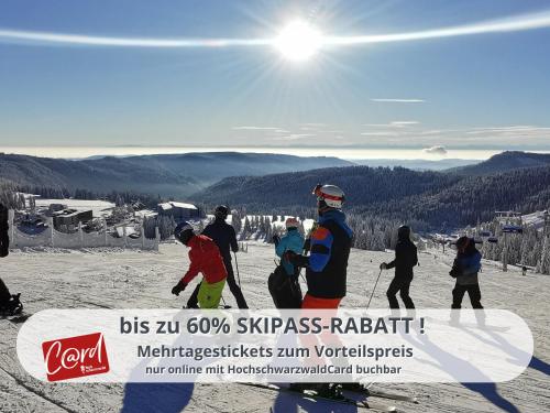 a group of people skiing on a ski slope at FeWo Schwarzwaldschick Feldberg I Direkt an der Piste I Whirlwanne I Tiefgarage I Skipass vergünstigt in Feldberg