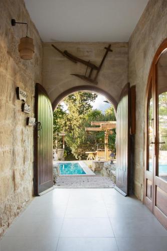 an archway leading to a swimming pool in a house at Private Villa in Naxxar