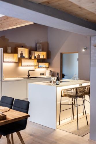 a kitchen and dining room with a table and chairs at chalet atelier Luxuriöses Chalet mit alpinem Charme in Telfes im Stubai