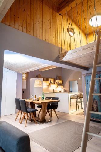 a dining room and kitchen with a table and chairs at chalet atelier Luxuriöses Chalet mit alpinem Charme in Telfes im Stubai