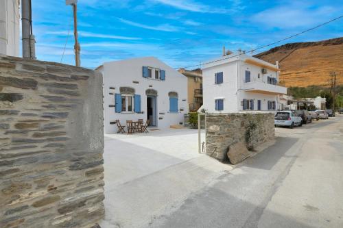a building with a stone wall next to a street at Stylish villa Antika close to the shops and restaurants in Korissia, Kea in Korissia