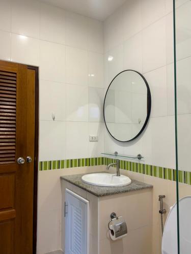 a bathroom with a sink and a mirror at Sea sand Bungalow in Phuket