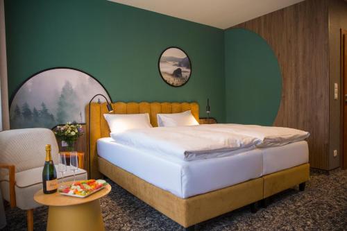 ein Schlafzimmer mit einem Bett und einer grünen Wand in der Unterkunft Santa Christina in Świeradów-Zdrój