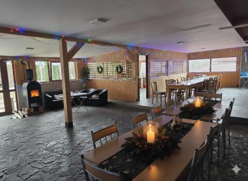 a large room with tables and chairs and a fireplace at Cornu Complex MEM in Campina