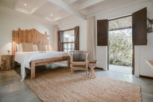 a bedroom with a bed and a table and a chair at Gonana Guesthouse in Paternoster