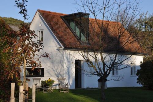 a white house with a red roof at Weinberg 12 in Fehring