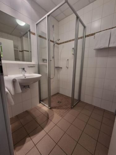 a bathroom with a shower and a sink at Die Heilsbach gGmbH in Fischbach bei Dahn