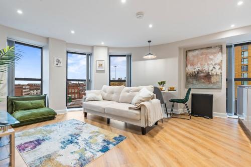 a living room with a couch and a table at Penthouse Apartment in Central Leeds Near Train Station Free WiFi Free Parking in Central Station