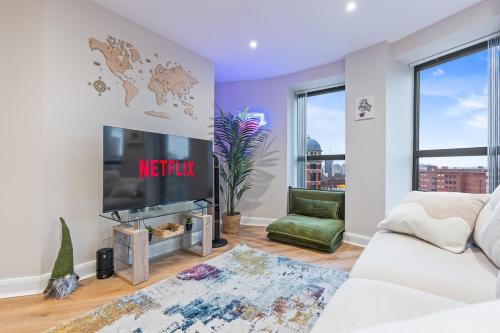 a living room with a tv and a couch at Penthouse Apartment in Central Leeds Near Train Station Free WiFi Free Parking in Central Station