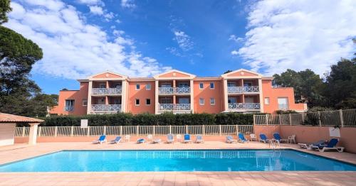 a large house with a swimming pool and chairs at T1 bis rénové, clim et confort - Saint Raphaël in Saint-Raphaël