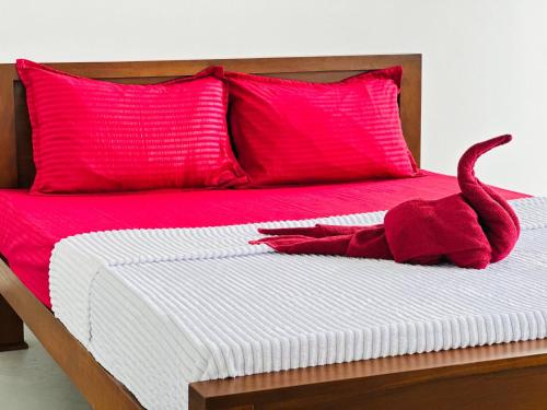 En eller flere senge i et værelse på Pearl Beach