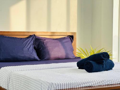 En eller flere senge i et værelse på Pearl Beach