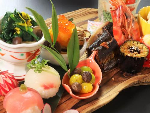 a tray of sushi and vegetables on a table at Oyado Yunosato in Shirakawa