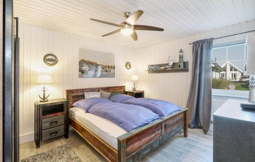 a bedroom with a bed and a ceiling fan at Haus Ankerplatz in Wandlitz