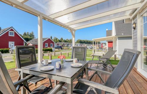 a patio with a table and chairs on a deck at Haus Ankerplatz in Wandlitz