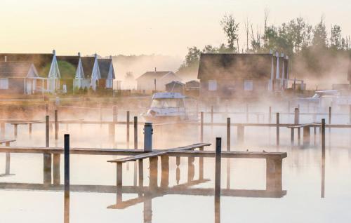 a boat is sitting on the water in the fog at Haus Feldblick in Wandlitz