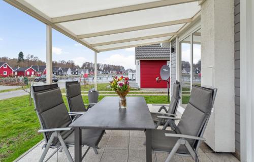 a table and chairs on a patio with awning at Haus Hafen Liebe in Wandlitz