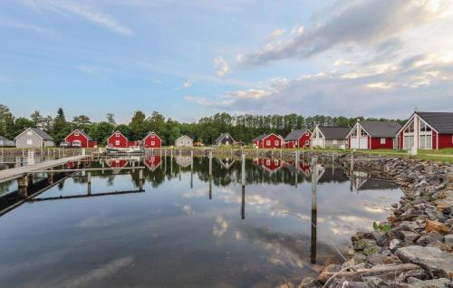 a group of houses on a lake with a reflection in the water at Haus Hafen Liebe in Wandlitz
